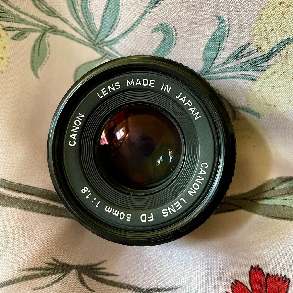 Canon FD 50mm f/1.8 lens with UV filter and drawstring lens bag